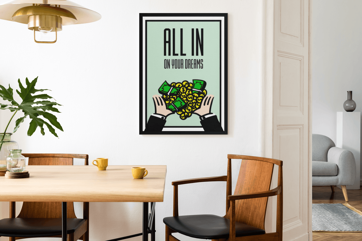 Black framed All In On Your Dreams print on a white dining room wall with oak table