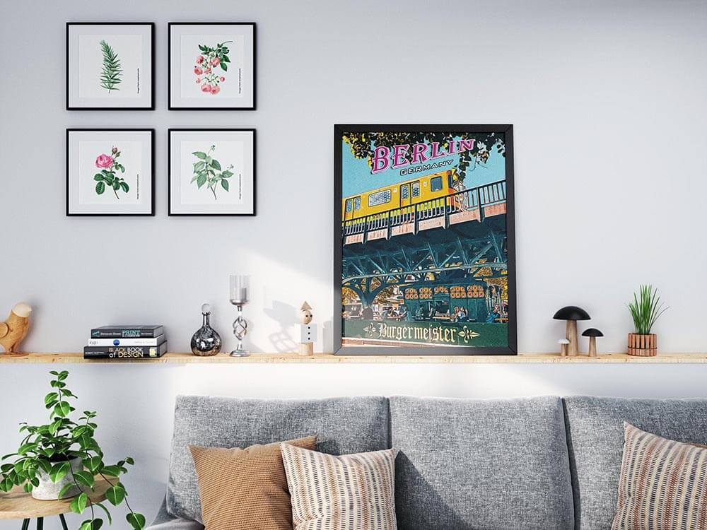 Berlin Burgermeister poster on a living room shelf next to botanical prints above a grey sofa