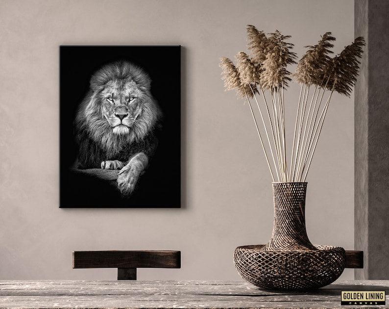 Black and white lion wall art on a warm beige plaster wall beside dried pampas in a woven vase