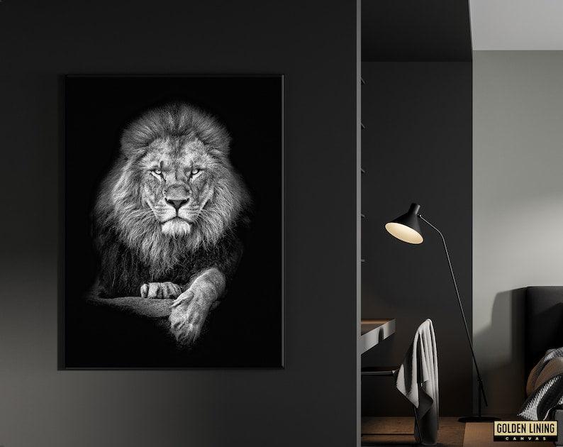 Framed monochrome lion canvas on a charcoal wall next to a black floor lamp in a dark bedroom