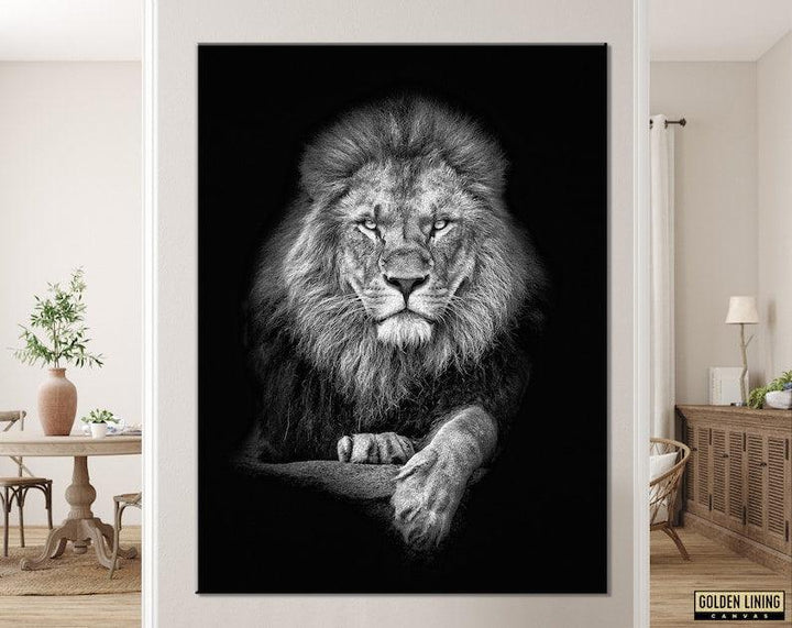 Black and white lion portrait canvas hanging on a pale wall above a rustic dining table