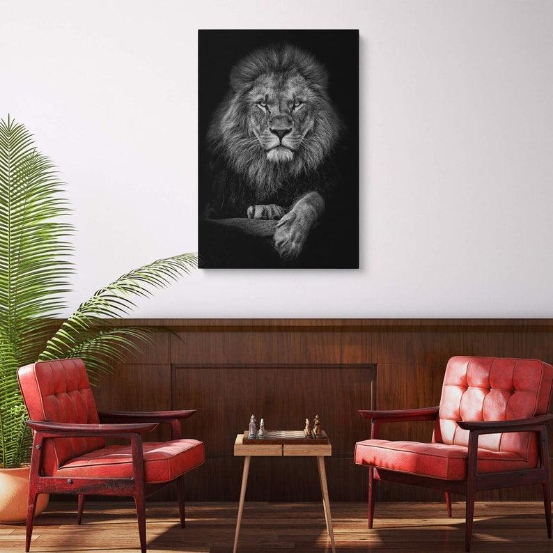 Monochrome lion canvas above walnut panelling flanked by two red leather armchairs and a chess table