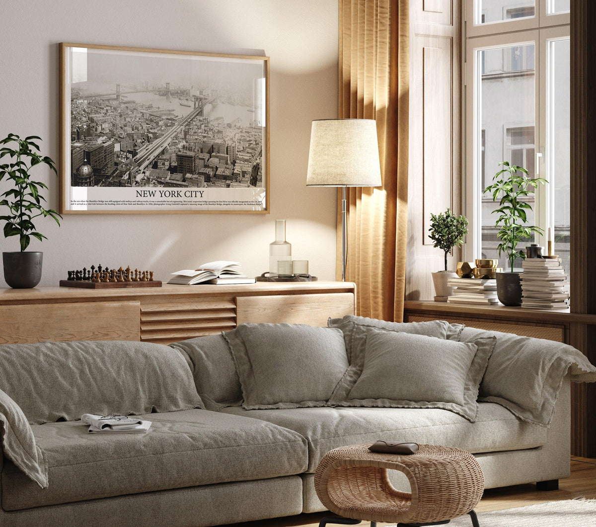 Oak framed vintage Brooklyn Bridge aerial photo on a warm beige living room wall above a linen sofa