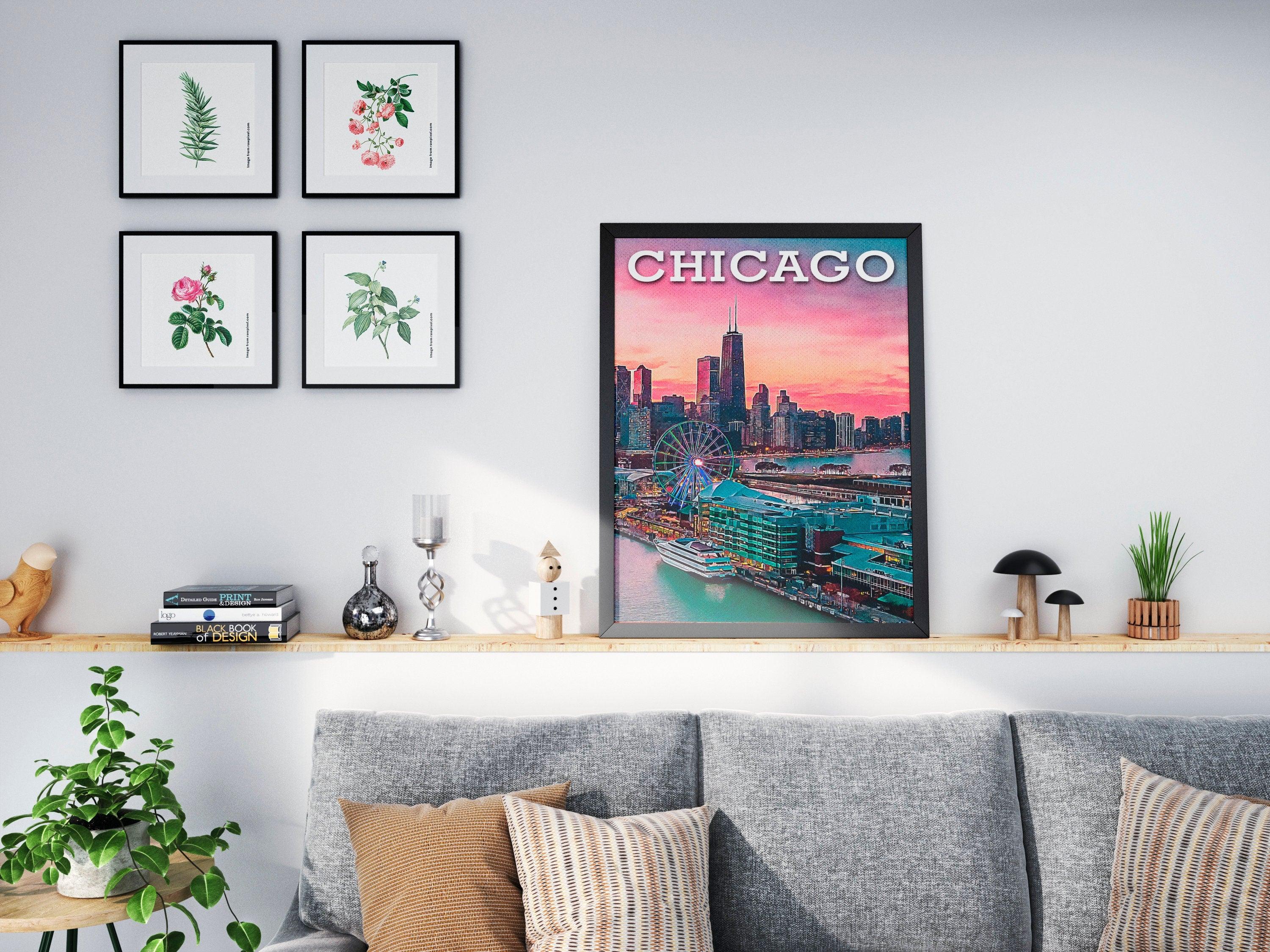 Chicago Navy Pier poster in black frame above a grey sofa with botanical prints nearby