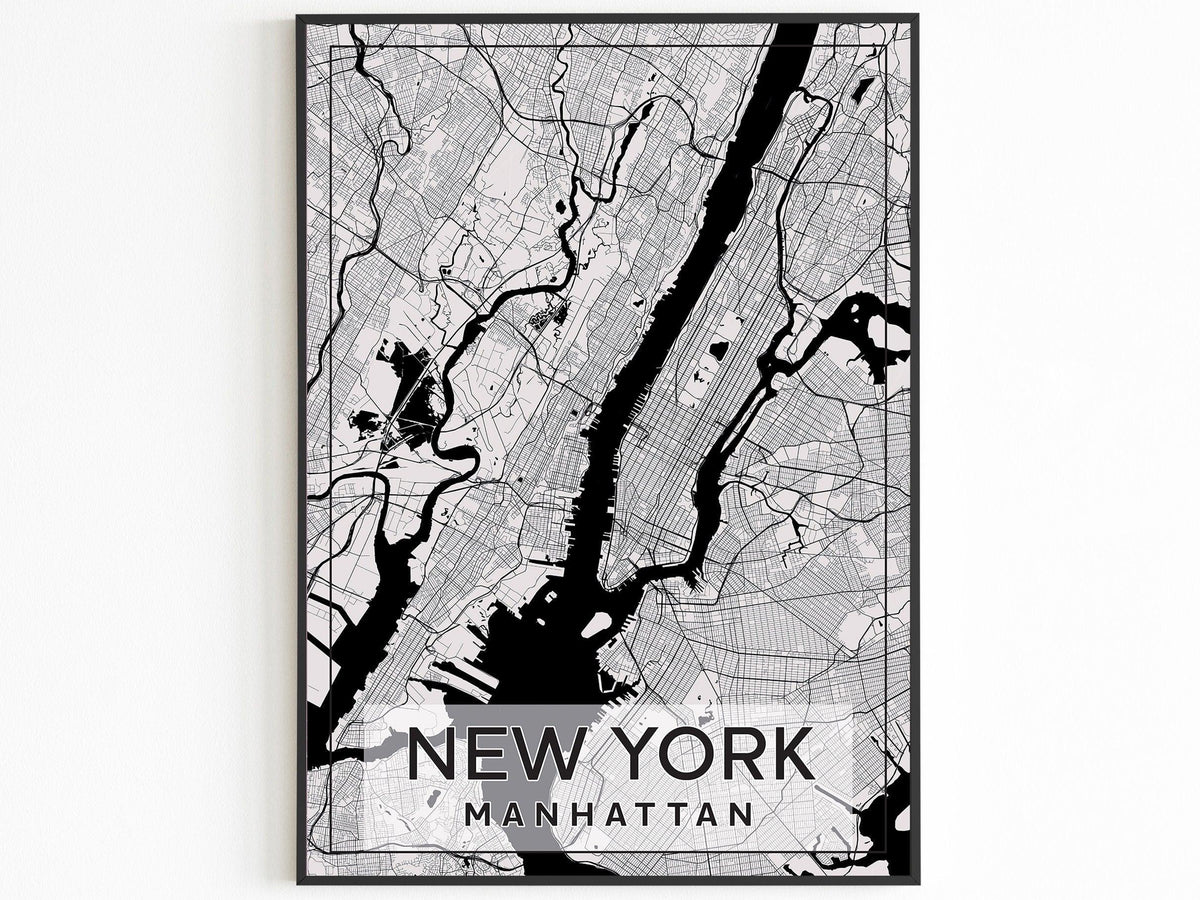 Black framed Manhattan street map poster reading New York Manhattan on a white wall