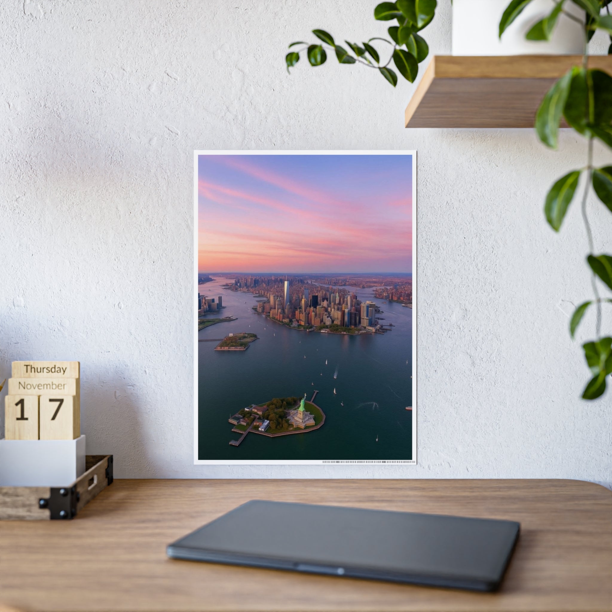 Manhattan sunset print leaning on a white wall behind a wooden desk and calendar blocks