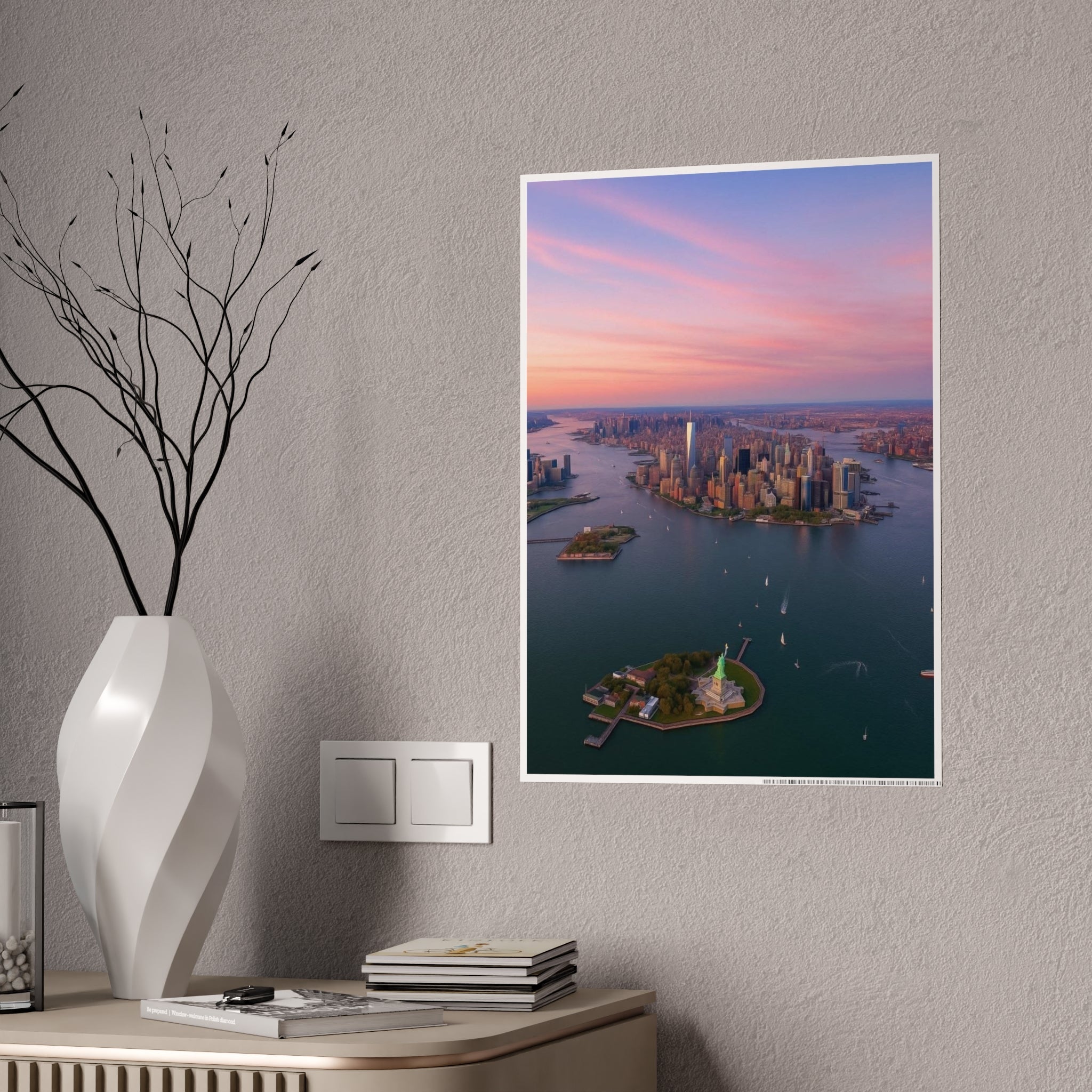 NYC sunset skyline poster hung on a grey wall above a console with white vase