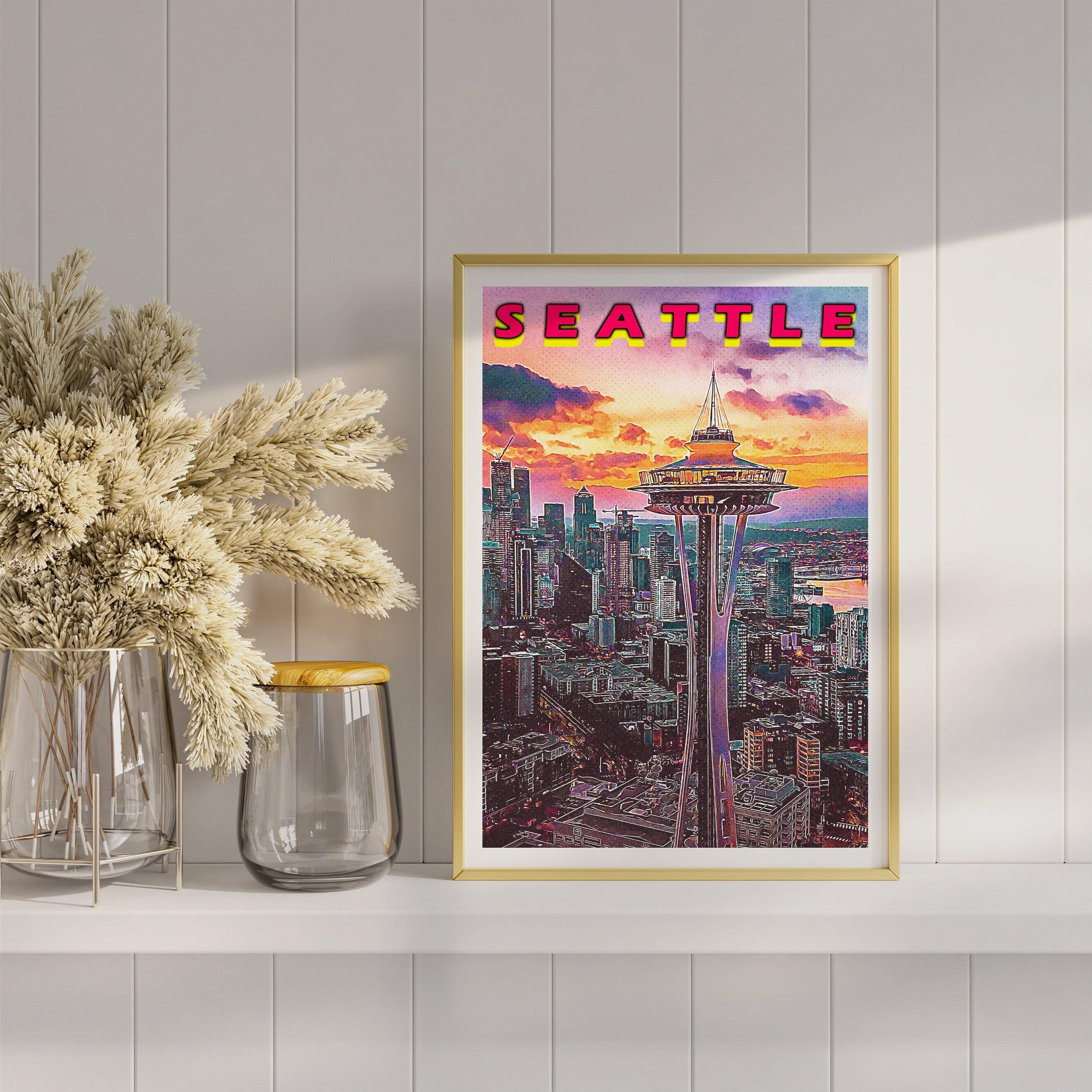 Close up of Seattle poster in gold frame with pampas grass, vivid purple and orange sunset clouds